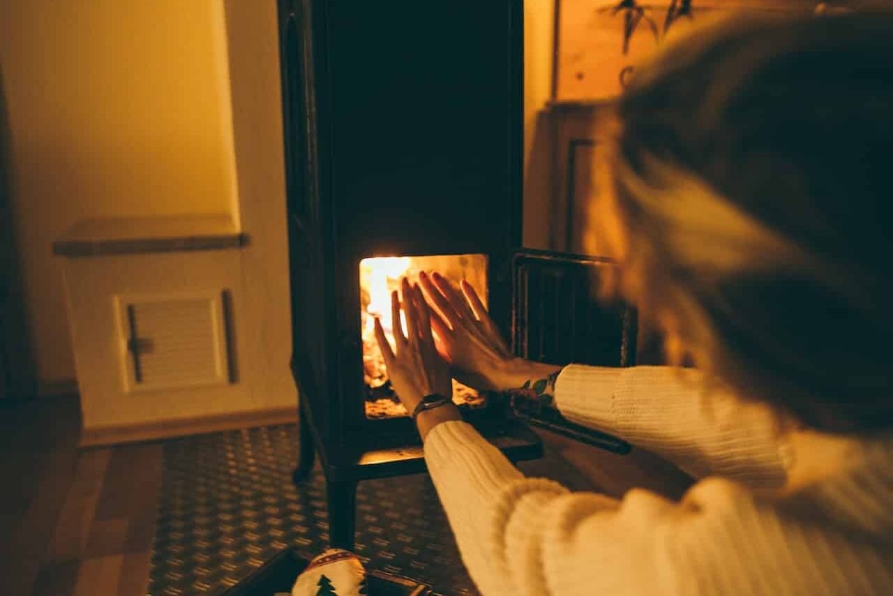 woman using heater at home