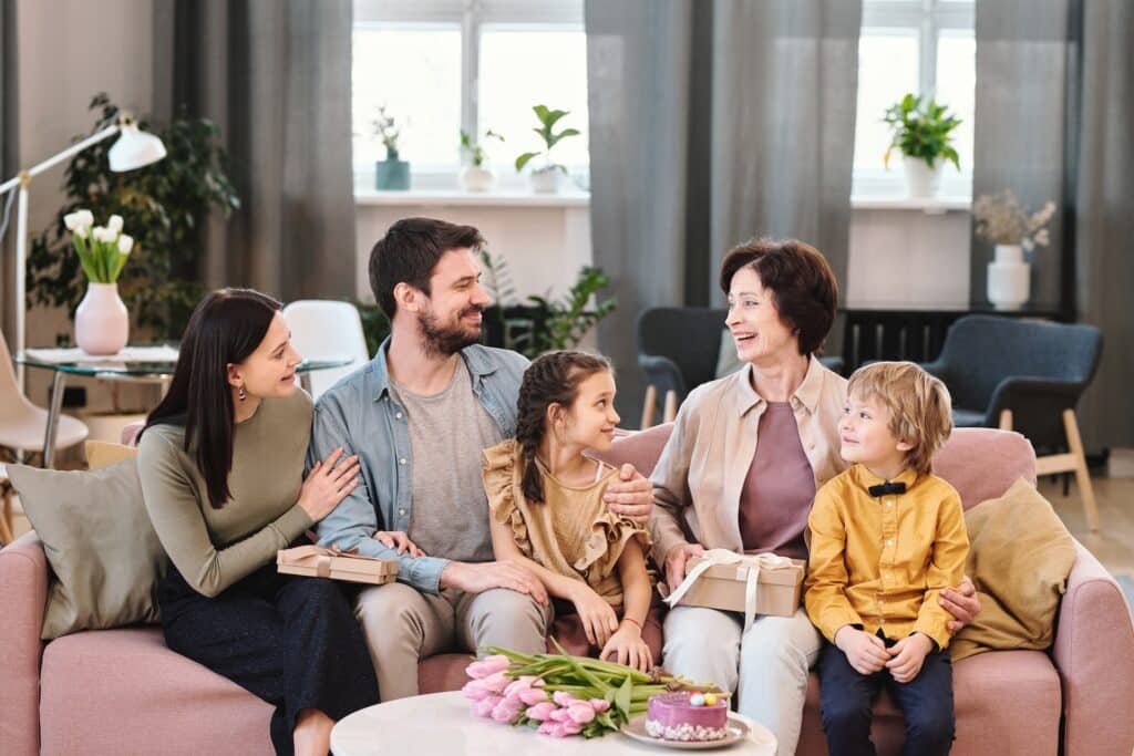 family sitting on sofa